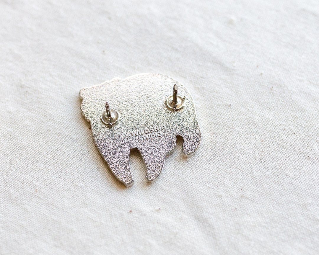 the backside of silver moon bear enamel pin
